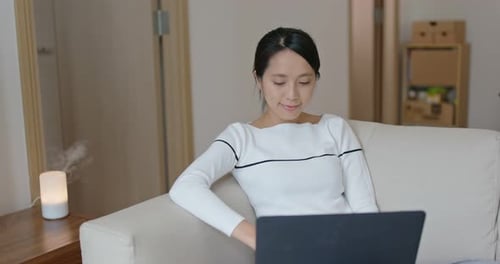 Woman Type on Computer at Home