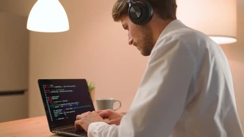Male Programmer is Working on Creating Software Typing Program Code on a Laptop Keyboard Programmer