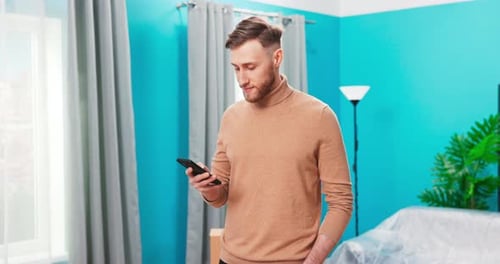 Happy Young Man Relaxing at New Home Holding Digital Tablet Enjoying Surfing Internet Study Work