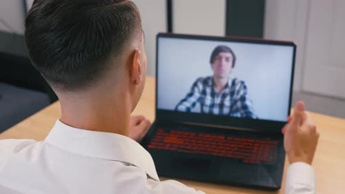 Man on Laptop Video Call with a Colleague