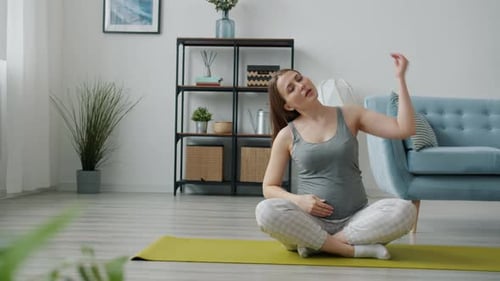 Active Pregnant Lady Doing Stretching Exercises Then Relaxing in Lotus Position on Yoga Mat