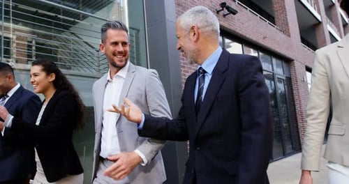 Group of Businesspeople Walking and Talking Outside