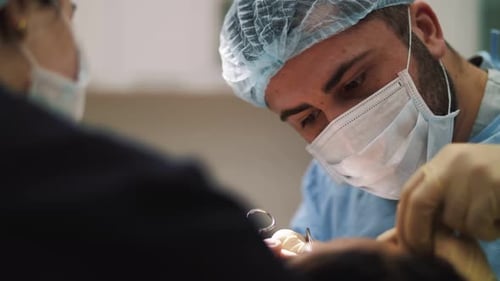 a man surgeon performs face and hands surgery close-up