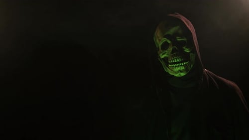 Scary Skeleton skull head figure in a hood for Halloween or horror videos