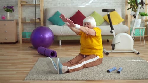 Active Senior Woman Doing Seated Stretches