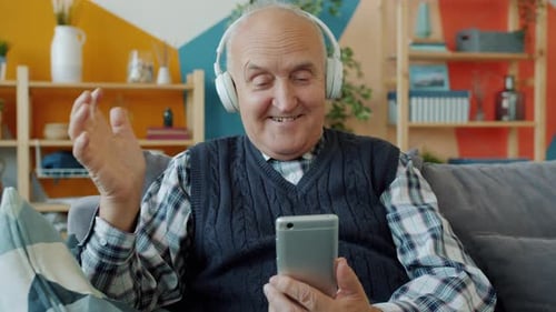 Senior Man Enjoying Music with Wireless Headphones