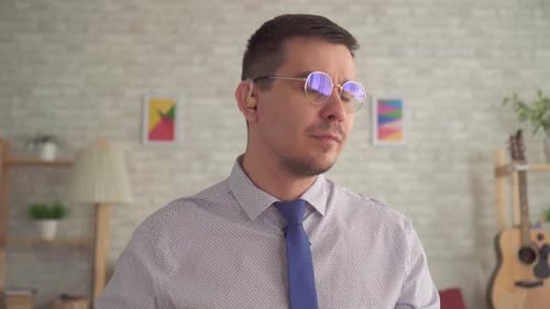 Adult Man with Glasses Speaks to Camera