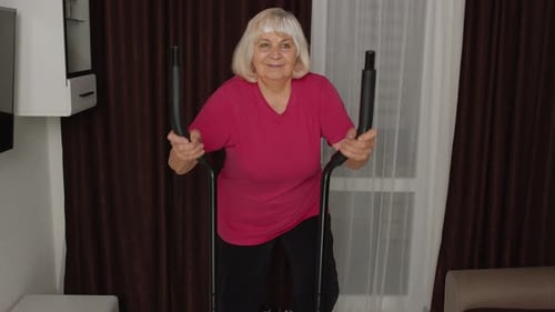 Senior Woman Using Elliptical Machine for Fitness