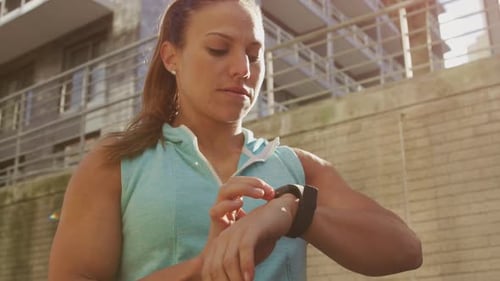 Athletic Woman Uses Fitness Tracker Watch