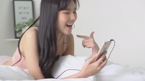 Woman Chatting on Phone Lying in Bed