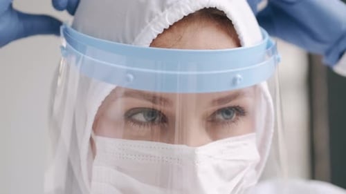 Adult in Full Protective Medical Gear and Face Shield
