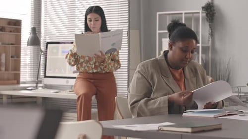 Multiethnic Female Colleagues Coworking in Office