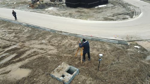 Aerial View Surveyors Measuring the Ground Level to Create a Landscape of Newly Created Construction