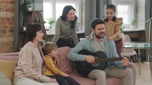 Family Sings and Plays Guitar Together at Home