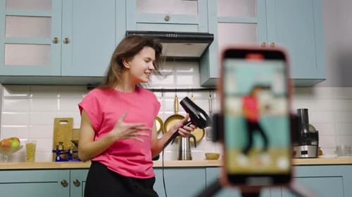 Girl Dancing, Singing, and Recording in Kitchen