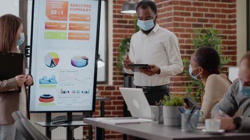 Team Giving Business Analytics Presentation in Modern Office