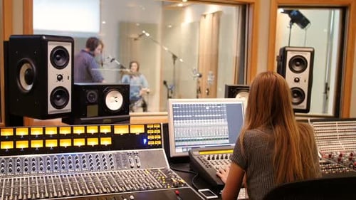 Female audio engineer using sound mixer