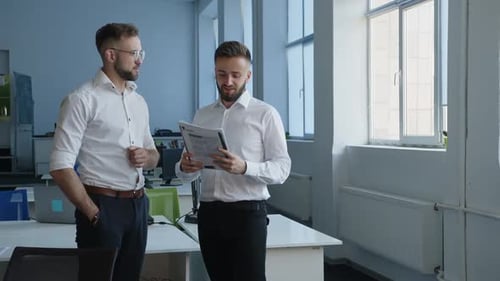 Business Professionals Reviewing Documents in Modern Office