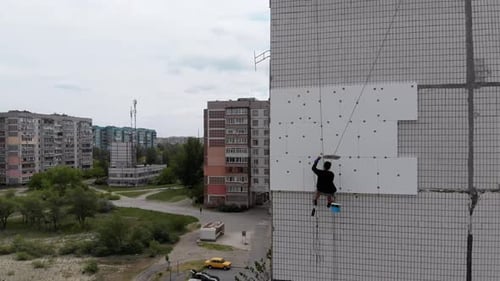 Industrial Alpinism. Aerial View. Work on Outer Insulate Building with Styrofoam