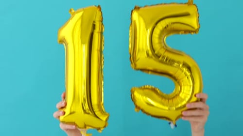 Shiny Balloons Spell Fifteen on a Blue Background