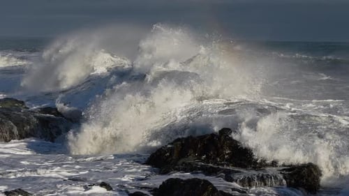 Rolling Waves Crashing To Rocky Shore