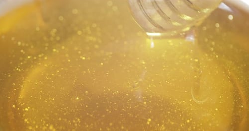 The Honey Is Stirred with a Wooden Spoon.