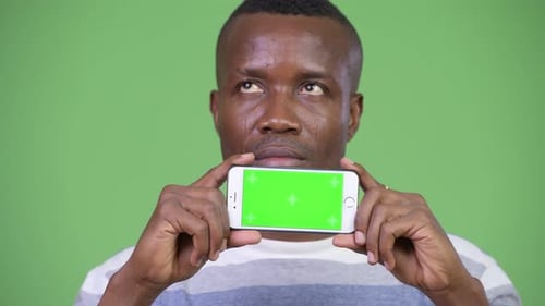 Adult Holds Smartphone with Green Screen Technology
