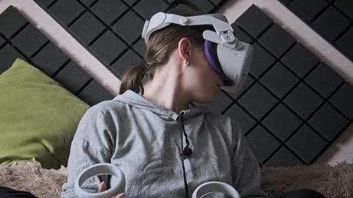 Woman Experiencing Virtual Reality with Headset and Controllers