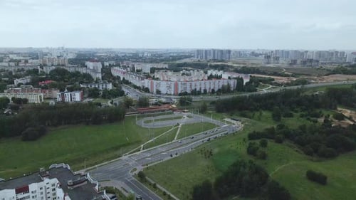 Railway station in the suburbs. A train passes through the station.