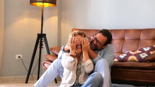 Playful Couple Laughing Together at Home