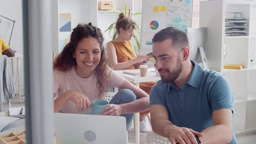 Two Colleagues Having Rest in Office