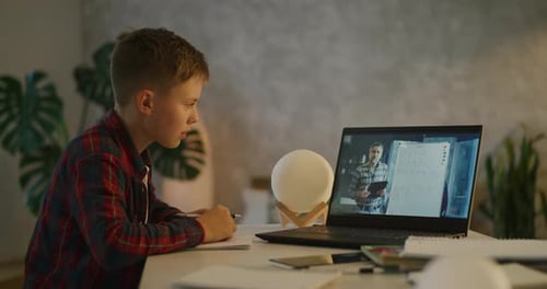 Young Boy Attending Online Math Lesson at Home