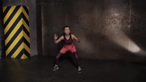 Athletic Beautiful Woman Doing Exercises in the Gym