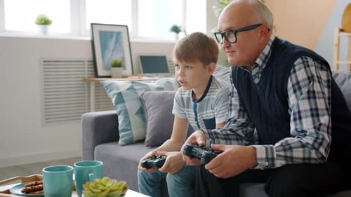 Grandfather and Grandson Playing Video Games Together