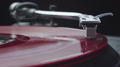 Spinning Red Vinyl Record on Turntable Close Up