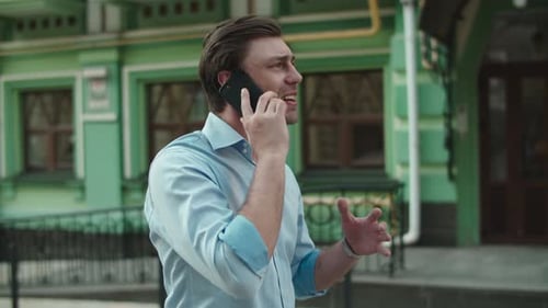 Businessman Having Talk on Mobile Phone. Man Talking Phone in Shirt at Street