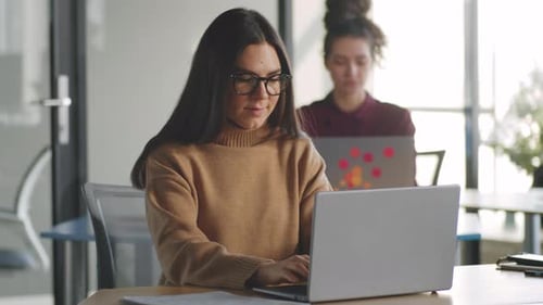 Brunette Woman Working on Laptop in Office