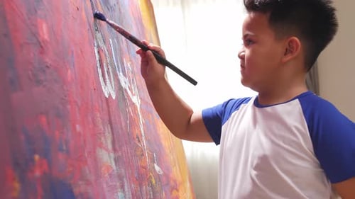 Child Painting Abstract Art on Canvas Indoors