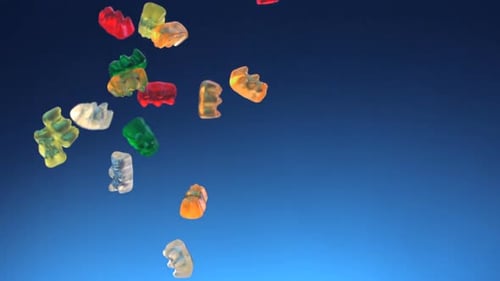Gummy Bears Falling on a Blue Background