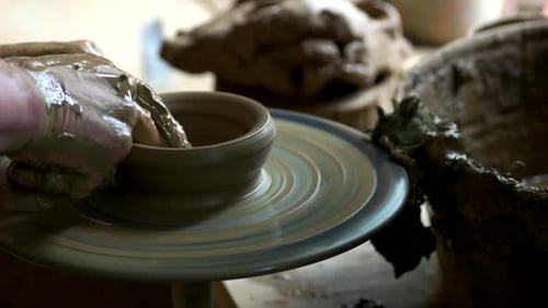 Potter's Hands Shaping Clay on Spinning Wheel