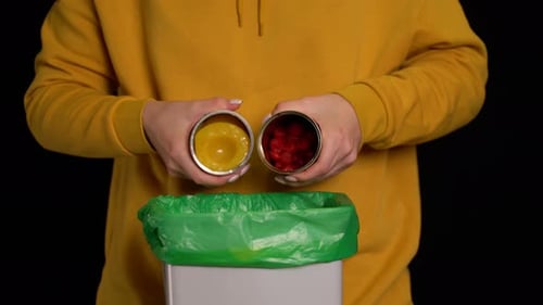 Woman Throws Out a Canned Food Strawberries, Peaches Into Garbage Bin
