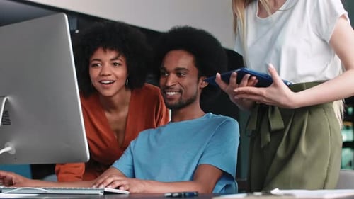 Team Working Together on Computer in Modern Office