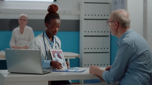 Doctor Explaining Heart Anatomy to Patient in Office