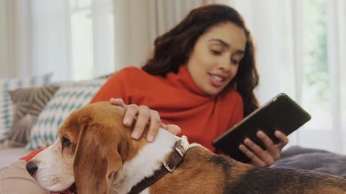 Woman Relaxing on Couch with Her Dog