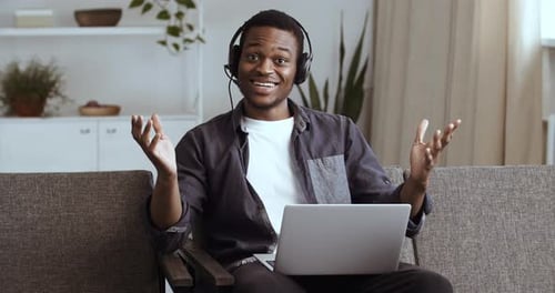 Enthusiastic Young Adult Using Laptop At Home