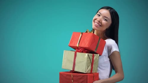 Woman Holding Beautiful Birthday Gifts and Smiling
