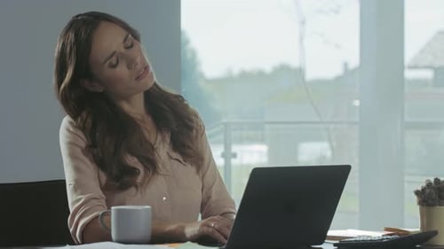Business Woman Trying To Relax. Tired Woman Relaxing at Remote Workplace