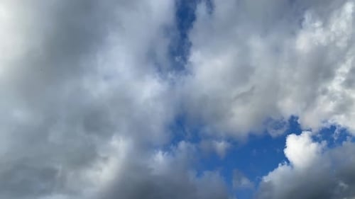 White Clouds Moving Across a Bright Blue Sky