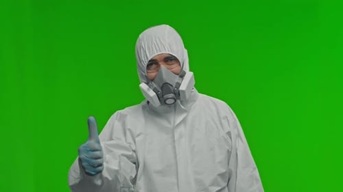 Person in Protective Suit Gives Thumbs Up on Greenscreen