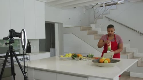 Woman Making Fruit Smoothie in Bright Kitchen